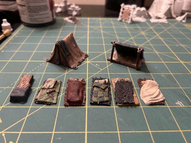 Several miniature tents and bedrolls painted.